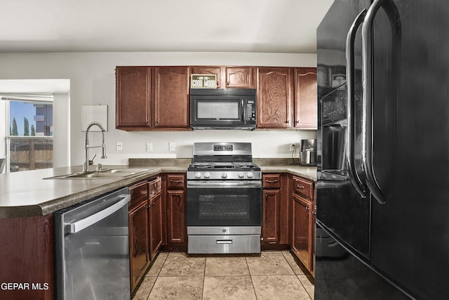 kitchen with black appliances, a sink, a peninsula, and dark countertops