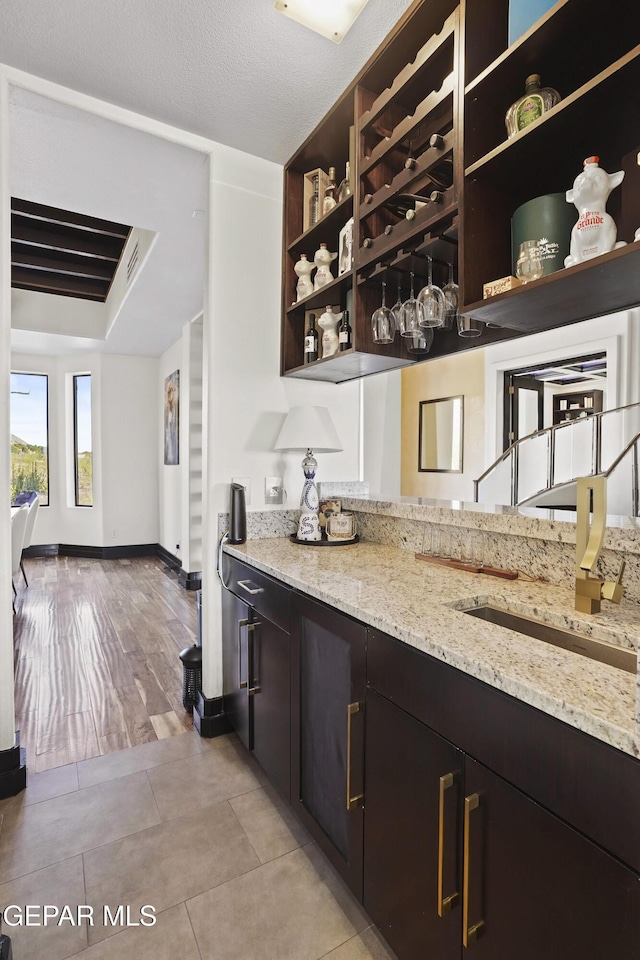 5905 Ojo De Agua Dr, El Paso, TX 79912 - bar area with light tile patterned flooring and baseboards