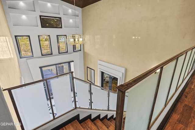 5905 Ojo De Agua Dr, El Paso, TX 79912 - staircase featuring a chandelier, a high ceiling, and wood finished floors