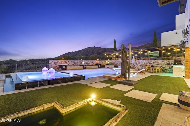 5905 Ojo De Agua Dr, El Paso, TX 79912 - pool at dusk with a patio and a mountain view