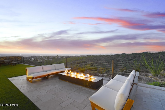 5905 Ojo De Agua Dr, El Paso, TX 79912 - patio terrace at dusk featuring an outdoor living space with a fire pit