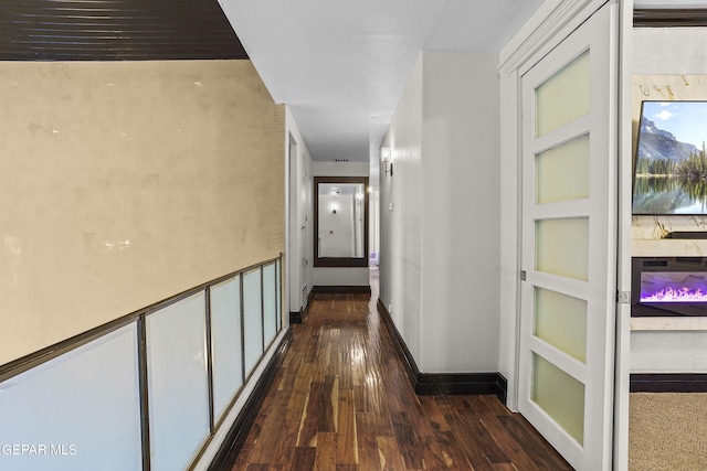 5905 Ojo De Agua Dr, El Paso, TX 79912 - corridor with dark wood-style floors and baseboards