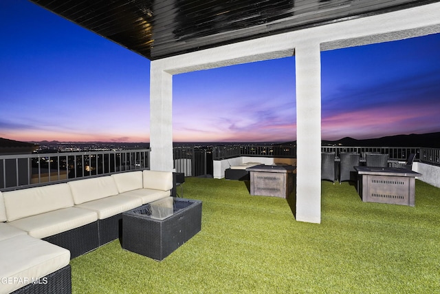 5905 Ojo De Agua Dr, El Paso, TX 79912 - patio terrace at dusk with an outdoor hangout area, a lawn, and area for grilling