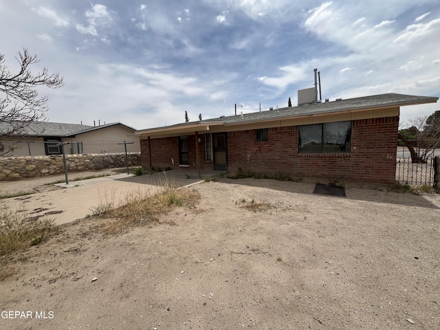 9885 Lilly Dr, El Paso, TX 79927 - back of house with fence, brick siding, and a patio area