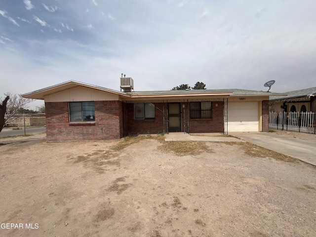 9885 Lilly Dr, El Paso, TX 79927 - ranch-style house with fence, a garage, brick siding, and driveway