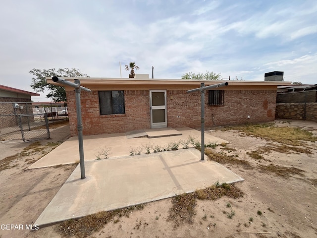 9874 Staubach Dr, El Paso, TX 79927 - back of property with fence, a patio, and brick siding
