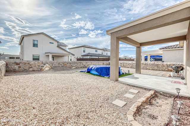 fenced backyard with a patio area