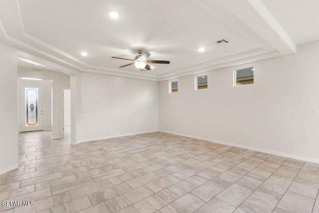 spare room featuring a ceiling fan, a tray ceiling, recessed lighting, and baseboards
