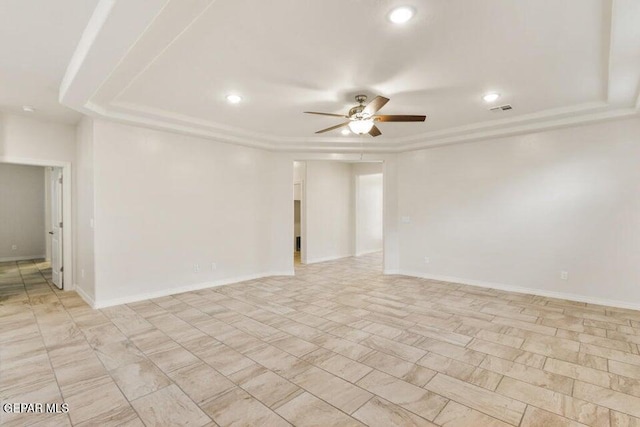 spare room featuring a ceiling fan, a raised ceiling, recessed lighting, and baseboards