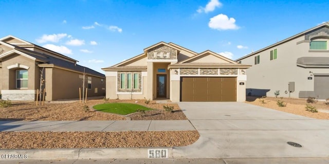 view of front of house featuring driveway, an attached garage, and stucco siding