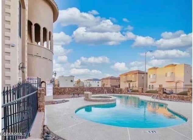 12281 Costa Brava Dr, El Paso, TX 79936 - community pool with fence, a hot tub, a residential view, and a patio area