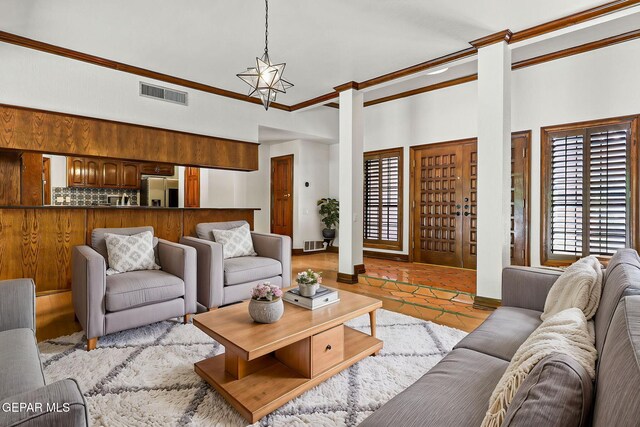509 Leslie Ward Ct, El Paso, TX 79922 - living area with ornamental molding, a towering ceiling, ornate columns, and light tile patterned floors