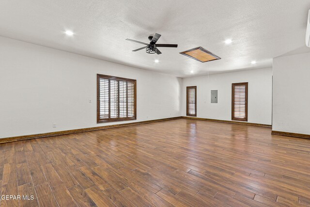 509 Leslie Ward Ct, El Paso, TX 79922 - spare room with plenty of natural light, ceiling fan, electric panel, wood finished floors, and a textured ceiling
