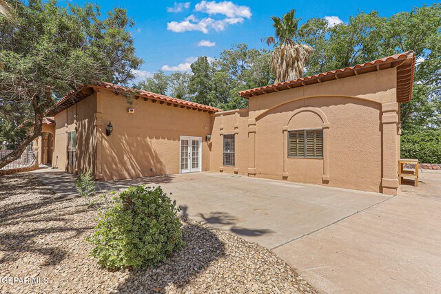 509 Leslie Ward Ct, El Paso, TX 79922 - back of property featuring a tile roof, french doors, stucco siding, and a patio