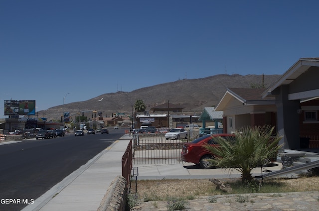 3825 Trowbridge Dr, El Paso, TX 79903 - view of asphalt street featuring a mountain view, street lights, and sidewalks
