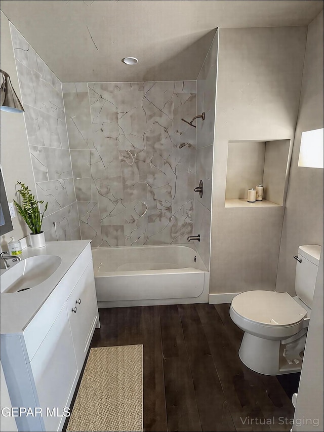 3825 Trowbridge Dr, El Paso, TX 79903 - bathroom featuring toilet, wood finished floors, tub / shower combination, and vanity