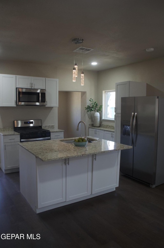 3825 Trowbridge Dr, El Paso, TX 79903 - kitchen with stainless steel appliances, a sink, light stone countertops, white cabinetry, and dark wood-style floors