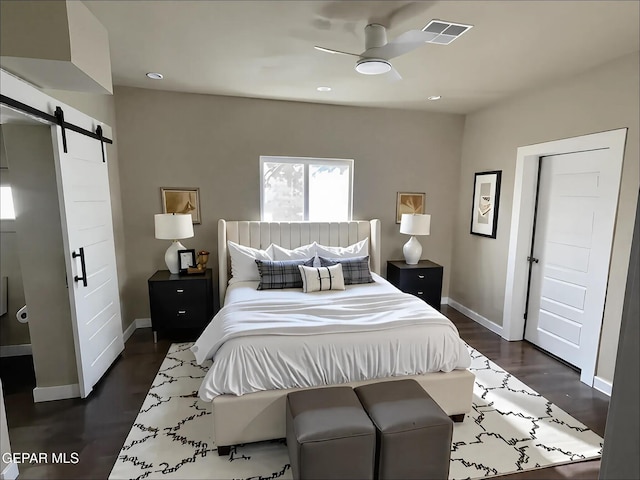 3825 Trowbridge Dr, El Paso, TX 79903 - bedroom featuring a barn door, baseboards, dark wood-style floors, and recessed lighting