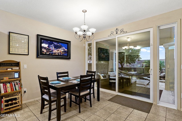 dining room featuring a chandelier, light tile patterned floors, and baseboards
