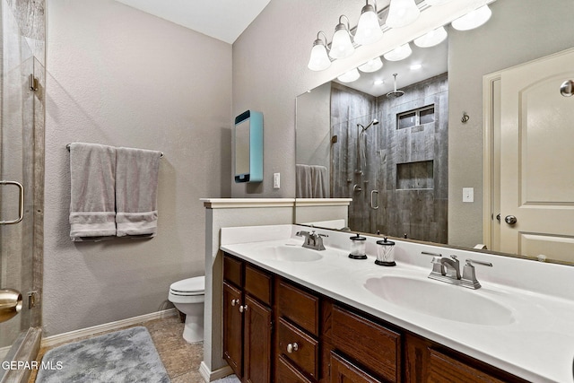 bathroom with a shower stall, toilet, double vanity, baseboards, and tile patterned flooring
