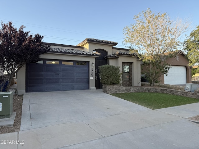14233 Richard Wiles Ave, El Paso, TX 79938 - mediterranean / spanish house featuring stucco siding, concrete driveway, an attached garage, and a tile roof
