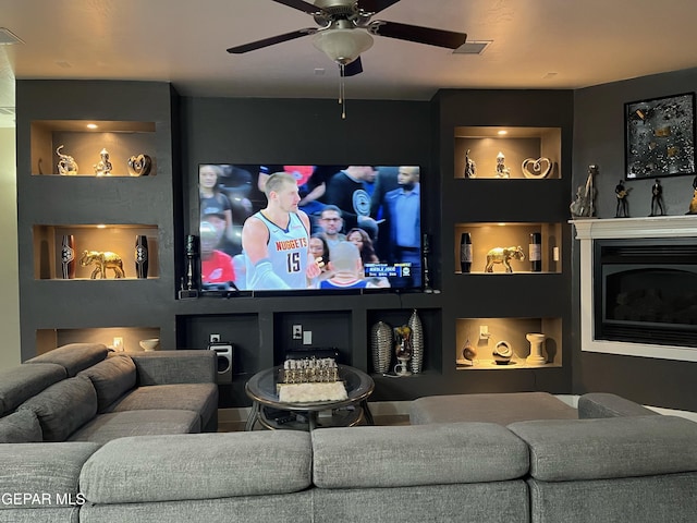 14233 Richard Wiles Ave, El Paso, TX 79938 - home theater room with a ceiling fan, a fireplace, and built in shelves