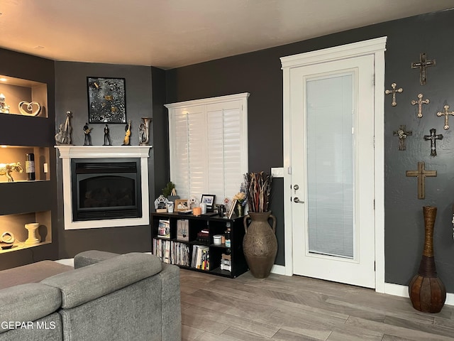 14233 Richard Wiles Ave, El Paso, TX 79938 - living room featuring a glass covered fireplace and baseboards