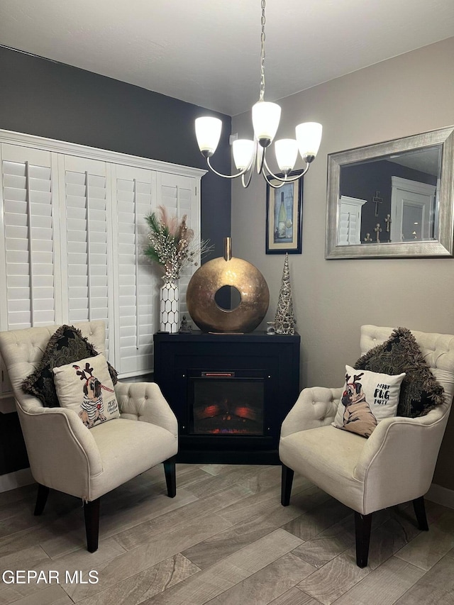 14233 Richard Wiles Ave, El Paso, TX 79938 - living area featuring a chandelier, wood finished floors, and a glass covered fireplace