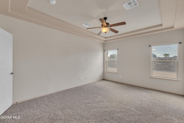 13824 Hollywood Dr, Horizon City, TX 79928 - carpeted empty room featuring a tray ceiling, a ceiling fan, and baseboards
