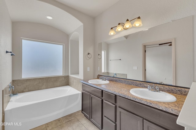 13824 Hollywood Dr, Horizon City, TX 79928 - bathroom featuring a garden tub, tile patterned floors, and double vanity