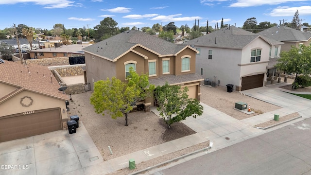 13824 Hollywood Dr, Horizon City, TX 79928 - view of front facade with stucco siding, concrete driveway, central AC, roof with shingles, and a garage