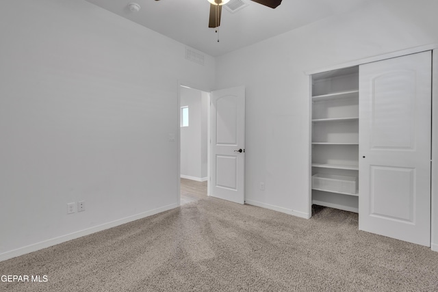 unfurnished bedroom featuring carpet, a closet, baseboards, and ceiling fan