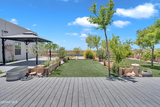 deck featuring a gazebo and a garden