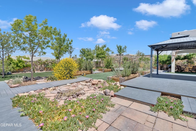 view of yard with a gazebo, a deck, fence, and a patio area