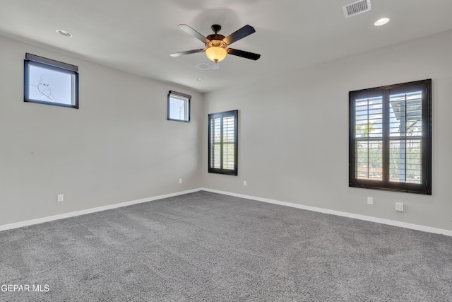 empty room featuring a ceiling fan, baseboards, dark colored carpet, and recessed lighting
