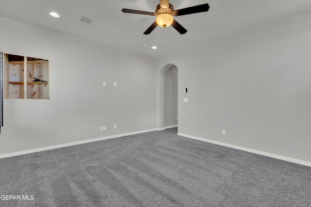 carpeted spare room featuring arched walkways, a ceiling fan, baseboards, and recessed lighting