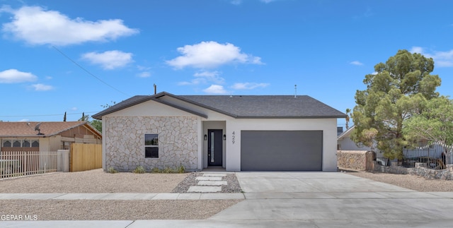 429 Lesa Ln, El Paso, TX 79915 - view of front of home with driveway, stone siding, a garage, and stucco siding