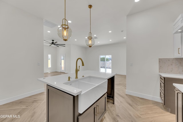 429 Lesa Ln, El Paso, TX 79915 - kitchen featuring a sink, light countertops, open floor plan, decorative light fixtures, and baseboards