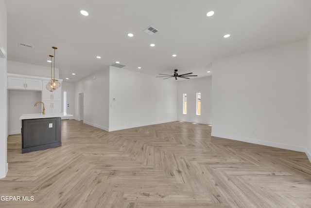 429 Lesa Ln, El Paso, TX 79915 - unfurnished living room with ceiling fan, baseboards, recessed lighting, and a sink