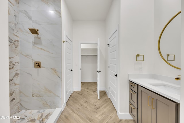 429 Lesa Ln, El Paso, TX 79915 - bathroom with tiled shower, vanity, and baseboards