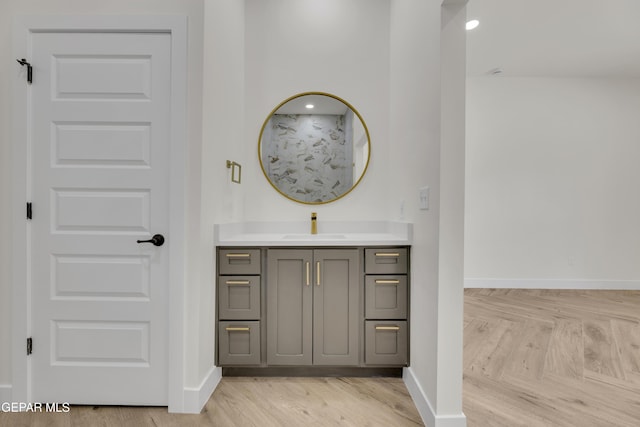 429 Lesa Ln, El Paso, TX 79915 - bathroom with baseboards, vanity, and wood finished floors