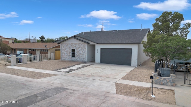 429 Lesa Ln, El Paso, TX 79915 - single story home with a garage, concrete driveway, stone siding, stucco siding, and a shingled roof