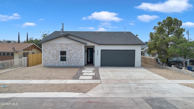 429 Lesa Ln, El Paso, TX 79915 - view of front of property with an attached garage, stone siding, concrete driveway, stucco siding, and a shingled roof