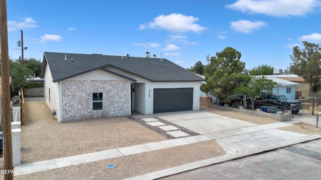 429 Lesa Ln, El Paso, TX 79915 - view of front of house featuring an attached garage, stone siding, stucco siding, concrete driveway, and a shingled roof