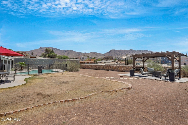 view of property's community with a pergola, a mountain view, a patio, fence, and a pool