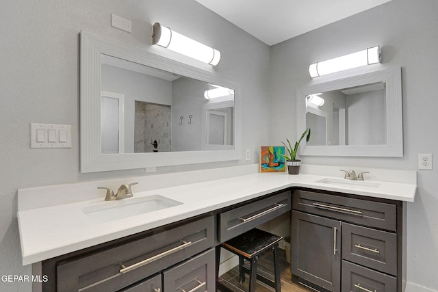 full bath featuring double vanity and a tile shower