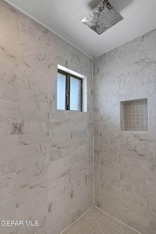 full bath with a tile shower
