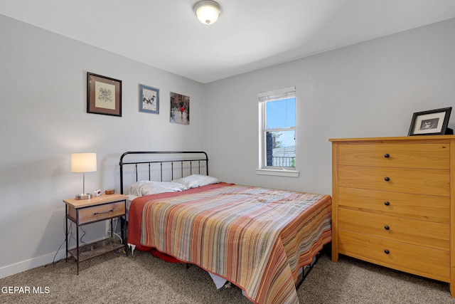 carpeted bedroom featuring baseboards
