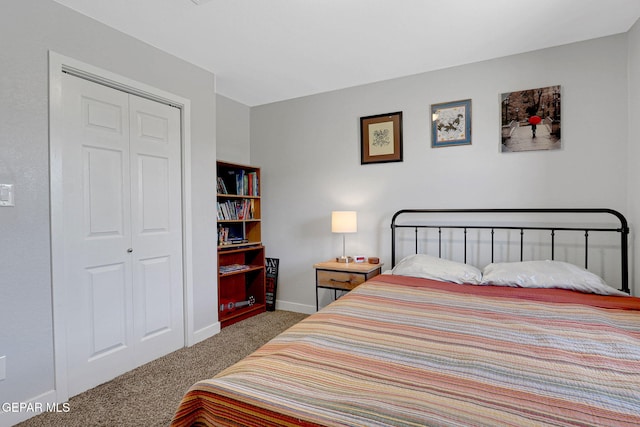 bedroom with carpet flooring, baseboards, and a closet
