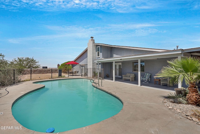view of pool featuring a patio and fence